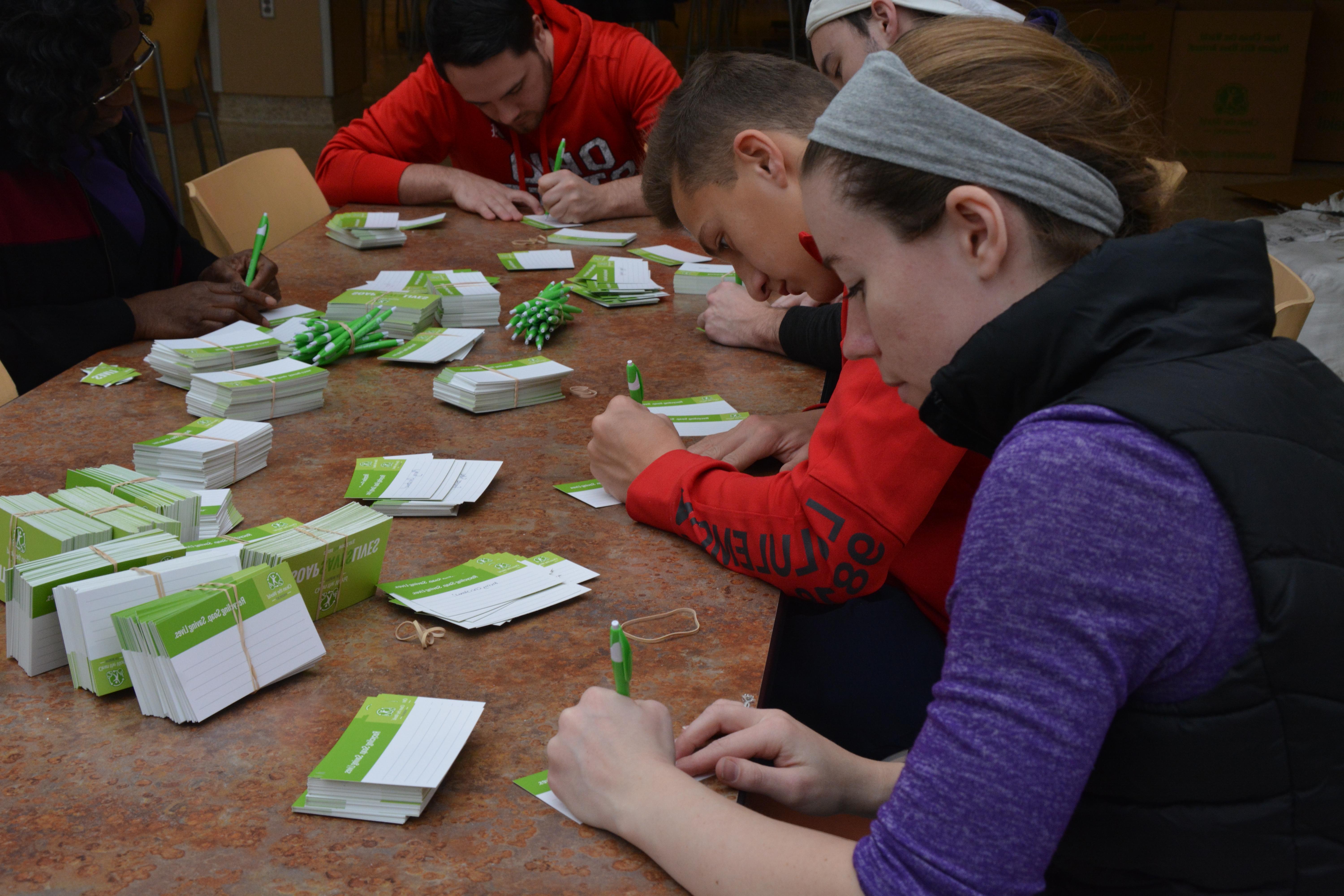 students writing on tags